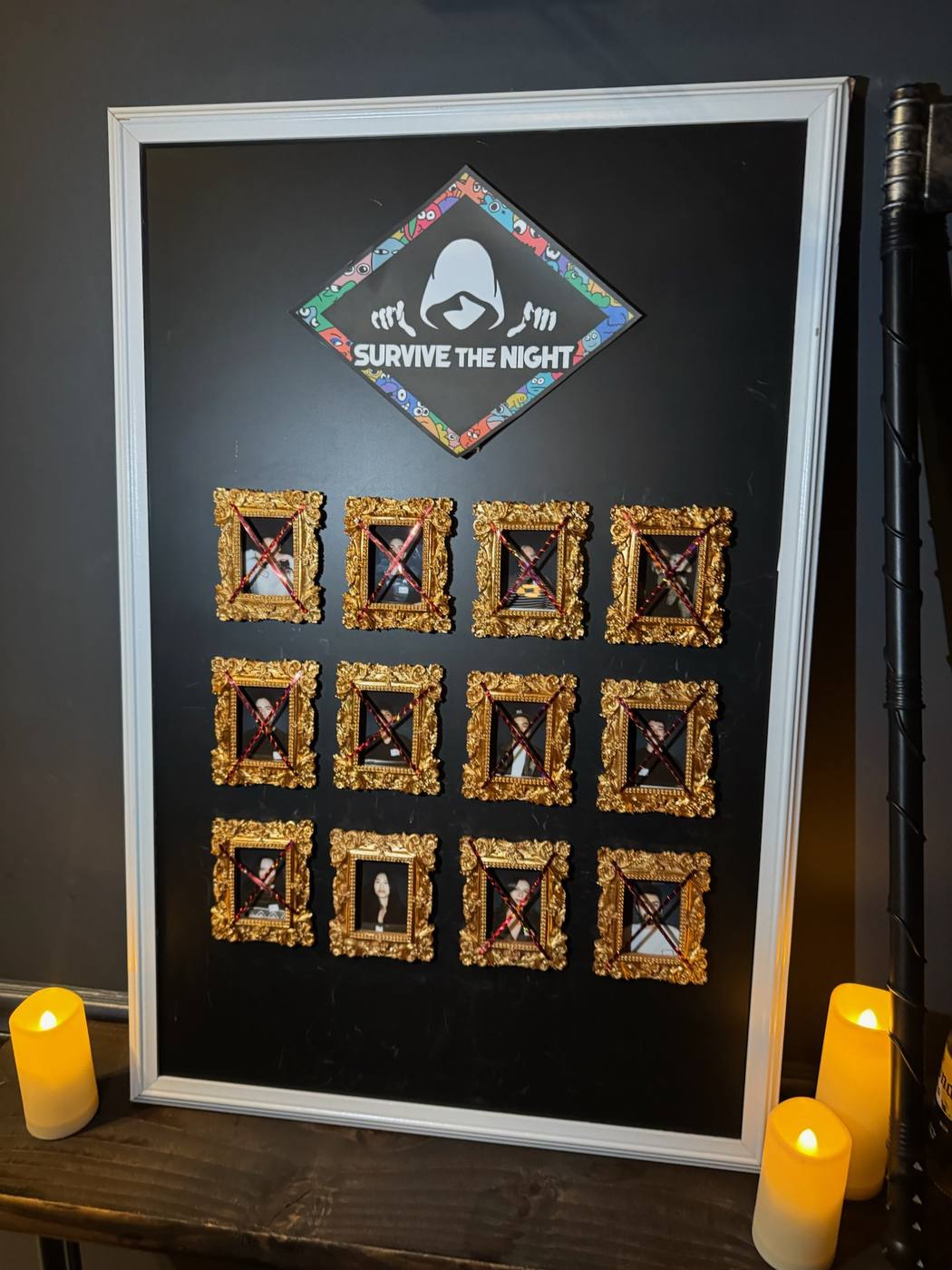 The Survive The Night elimination board with gold frames